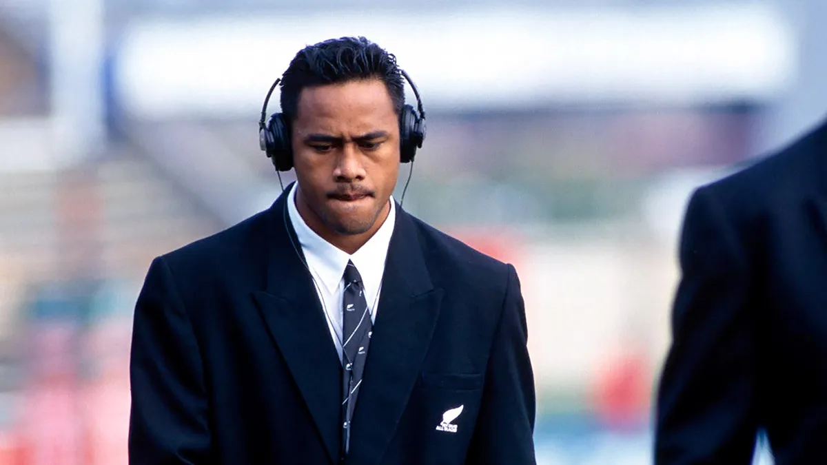 Jonah Lomu in an All Blacks suit and headphones